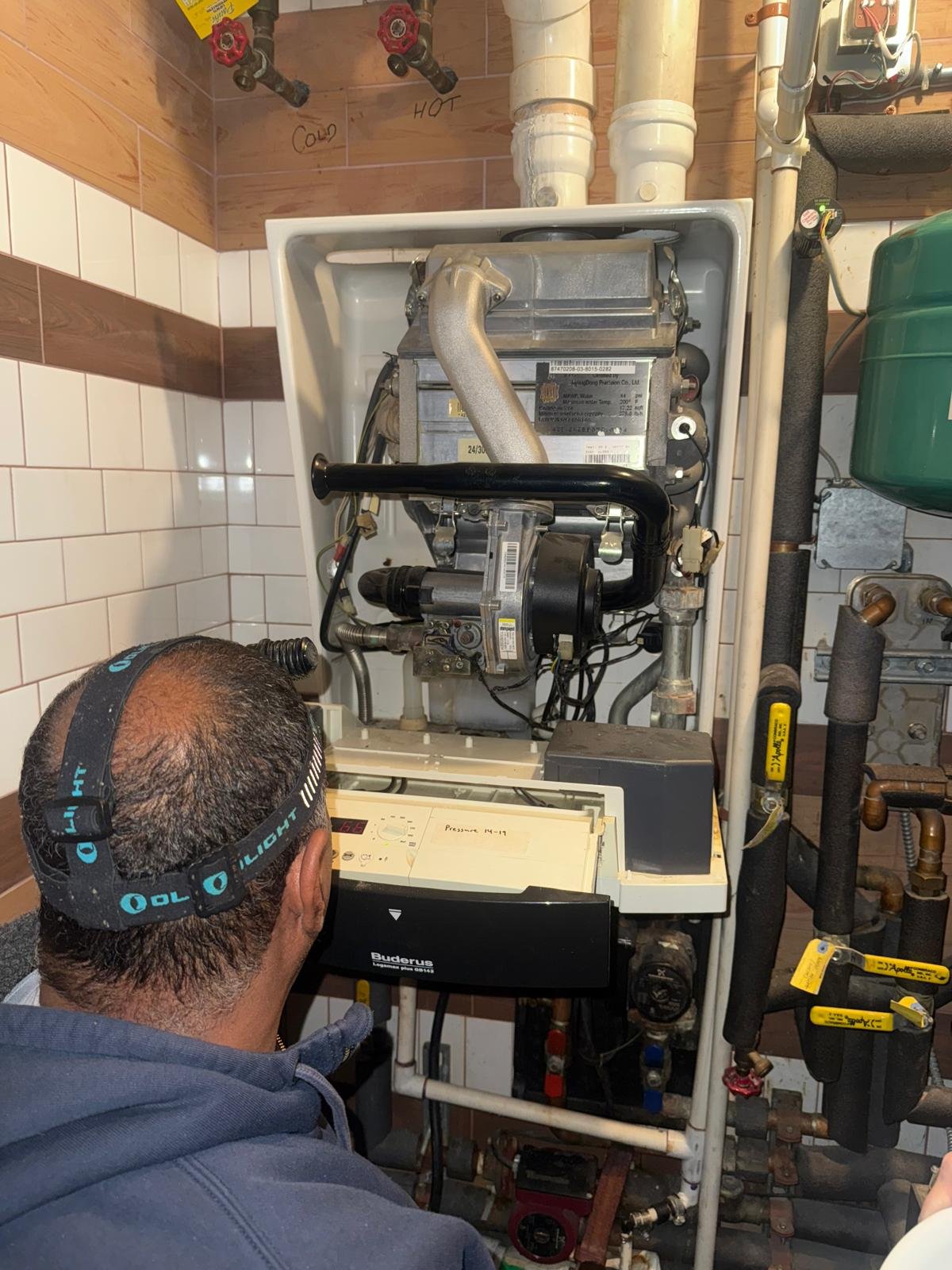 licensed plumber is repairing the boiler in Briarwood NY.